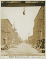 Progress of steel construction in Front St. at bent 108, looking north, showing crosswires, June 26, 1916.