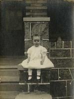 Little girl sitting on stone porch, Philadelphia.