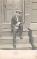 Young man sitting on stoop, Philadelphia.