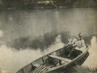 Group portrait of two girls sitting in wooden rowboat, Philadelphia.