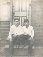 Two young men sitting on wooden stoop, Philadelphia.