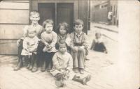 Boys and girls sitting on a doorstep, Philadelphia.