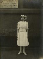 Girl standing in front of the First Association of Spiritualists Temple, Philadelphia.