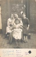 Four girls sitting on wooden stoop, Philadelphia.