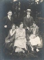 Two men and three women picnicing in wooded area, Philadelphia.