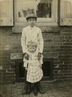 Boy and girl standing in front of window, Philadelphia.