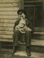 Young man in sailor uniform holding infant on wooden stoop, Philadelphia.