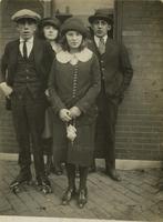 Two teenage men and two teenage women standing in front of window, Philadelphia.