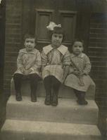 Three little girls sitting on marble steps, Philadelphia.