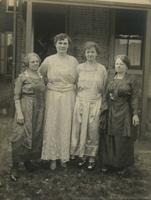 Four older women standing in grassy backyard, Philadelphia.