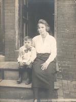 Woman with boy sitting on stoop, Philadelphia.