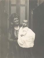 Woman with curly hair holding infant, Philadelphia.