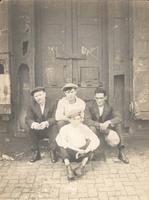 Four men sitting in front of large doorway, Philadelphia.