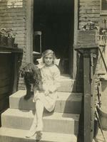 Young girl and dog sitting on marble steps, Philadelphia.