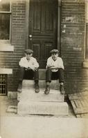 Two young men sitting on marble steps, Philadelphia.