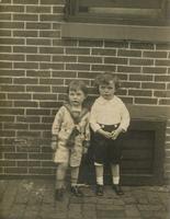 Two little boys in front of brick house, Philadelphia.