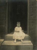Small girl sitting on marble steps, Philadelphia.