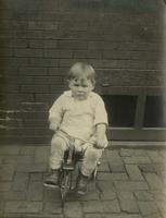 Little boy riding a small tricycle, Philadelphia.