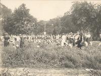 Large group of men, women, and children gathering in wooded area, Philadelphia.