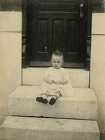 Small child sitting on marble steps, Philadelphia.
