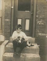Boy and his dog sitting on marble steps, Philadelphia.