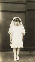 Little girl standing in her First Communion dress, Philadelphia.