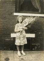 Young girl holding large bouquet of gladiolas, Philadelphia.