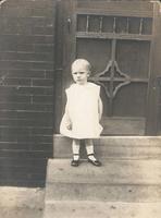 Frowning girl on steps, Philadelphia.