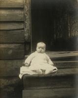 Infant sitting on wooden steps, Philadelphia.