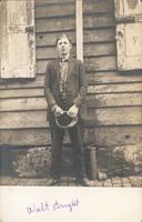 Young man standing in front of wooden house, Philadelphia.