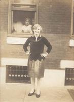 Young woman standing in front of window, Philadelphia.