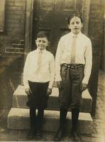 Two boys standing in front of house door, Philadelphia.