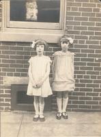 Two girls standing in front of window, Philadelphia.