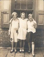 Three girls standing in front of window, Philadelphia.