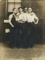 Four men standing outside a brick house, Philadelphia.