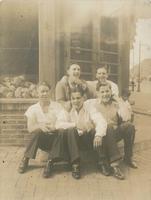 Five young men sitting outside a corner grocery store, Philadelphia.