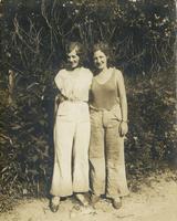 Two young women standing on dirt path, Philadelphia.