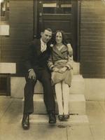 Young man sitting with a young woman on marble steps, Philadelphia.