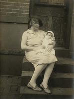 Woman with infant sitting on steps, Philadelphia.