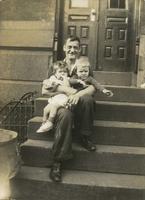 Man holding two small children on steps, Philadelphia.