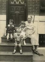 Three little girls sitting on wooden steps with an older woman, possible a grandmother, Philadelphia.