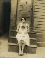 Smiling woman with infant sitting on her lap, Philadelphia.