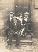 Three men and girl on wooden stoop, Philadelphia.