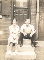 Man and woman sitting on marble steps, Philadelphia.