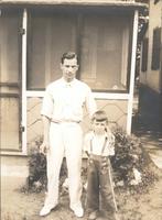 Man and boy standing outside a screened porch, Philadelphia.