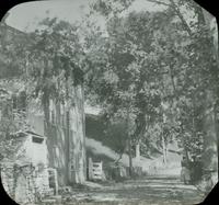 [Road beside old mill building.]