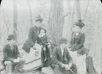 [Group portrait of the Doerings with Mrs. Lindsay in a wooded area.]