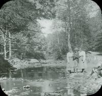 [Unidentified group standing on stones near a stream, Pocono Mountains, Pa.]
