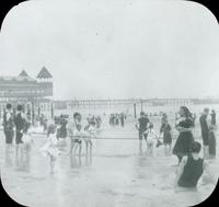 [Bathers wading through the water near a pier in Atlantic City, N.J.]