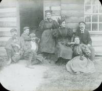 [Group sitting on steps of log outbuilding, Washington's Headquarters, Valley Forge, Pa.]